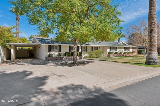 ranch-style house with a front lawn and a carport