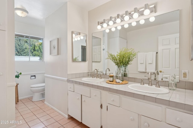 bathroom with vanity, tile patterned floors, and toilet