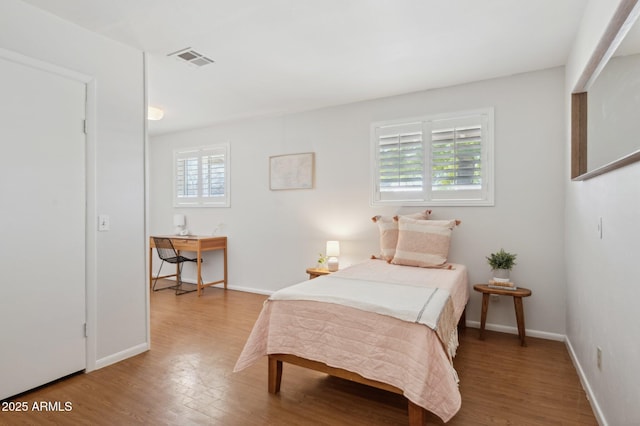 bedroom with wood-type flooring