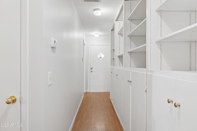 corridor featuring light hardwood / wood-style floors