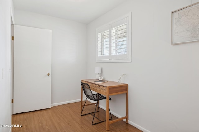 office with light hardwood / wood-style flooring