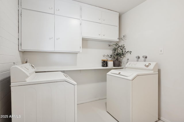 laundry room with cabinets and washer and clothes dryer