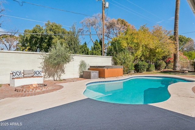 view of swimming pool featuring a hot tub and a patio