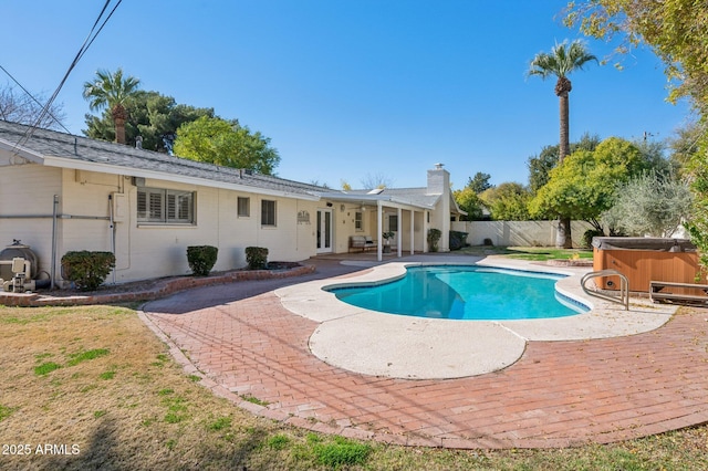 view of pool featuring a patio area and a hot tub