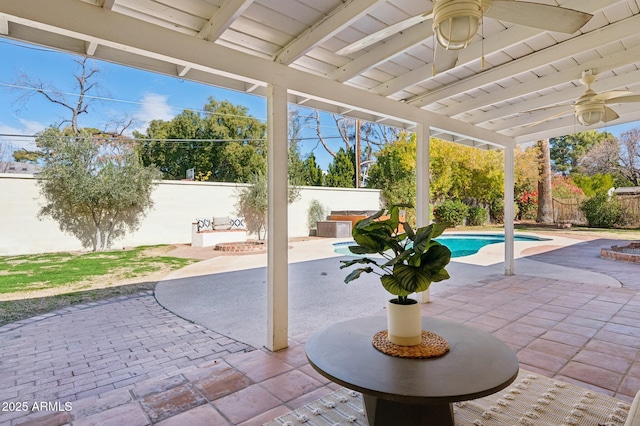 view of patio / terrace featuring a fenced in pool and an outdoor fire pit