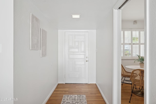 corridor with hardwood / wood-style floors