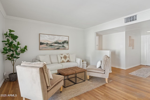 living room with hardwood / wood-style floors and crown molding