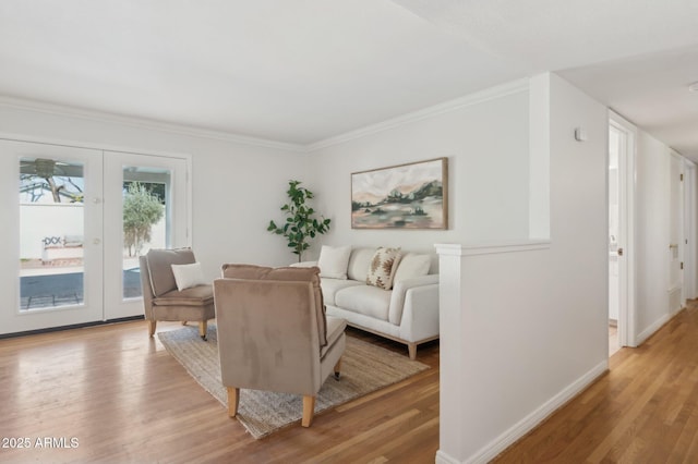 living room featuring crown molding and light hardwood / wood-style floors