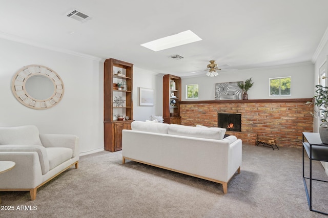 living room with light colored carpet, a fireplace, a skylight, and a wealth of natural light