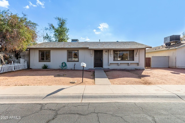 single story home featuring a garage and central air condition unit