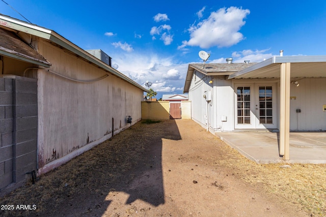 view of side of home featuring french doors and a patio area