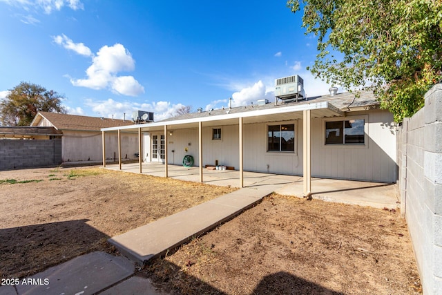 rear view of house featuring central AC, a patio area, and french doors