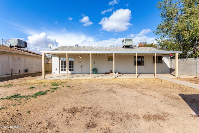 rear view of house featuring a patio and cooling unit