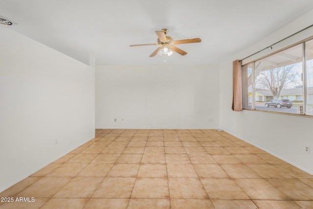 unfurnished room with ceiling fan and light tile patterned floors