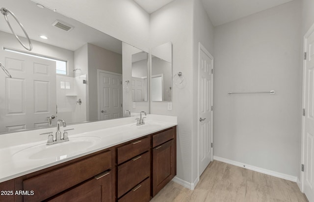 bathroom with vanity and a shower