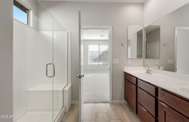 bathroom featuring vanity and a shower with shower door