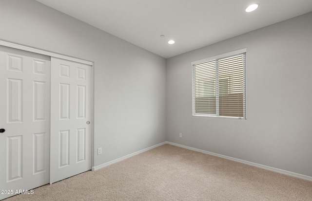 unfurnished bedroom featuring carpet floors and a closet