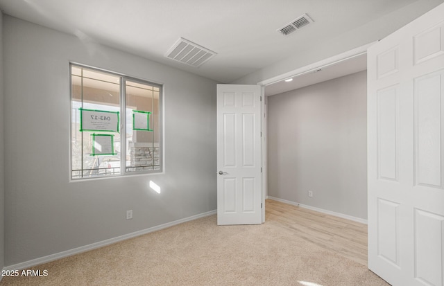 unfurnished bedroom featuring light carpet