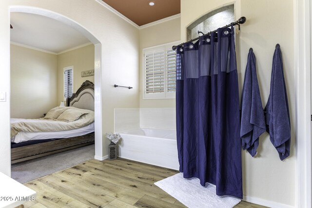 1123 E Shepherds Way, Casa Grande, AZ 85122 - bathroom featuring ensuite bathroom, ornamental molding, wood finished floors, a garden tub, and baseboards