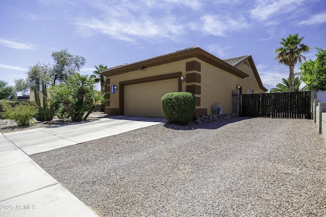 1123 E Shepherds Way, Casa Grande, AZ 85122 - view of home's exterior featuring concrete driveway, stucco siding, fence, and an attached garage
