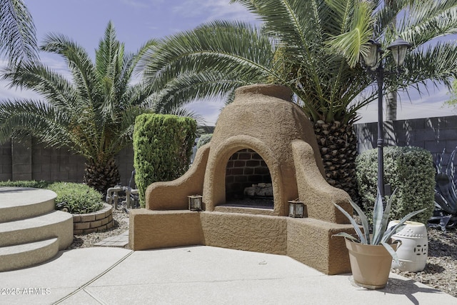 1123 E Shepherds Way, Casa Grande, AZ 85122 - view of patio / terrace with an outdoor fireplace and fence
