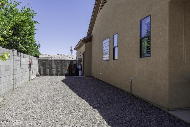 1123 E Shepherds Way, Casa Grande, AZ 85122 - view of side of home featuring stucco siding and fence