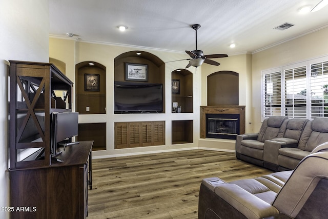 1123 E Shepherds Way, Casa Grande, AZ 85122 - living room with ornamental molding, recessed lighting, wood finished floors, a glass covered fireplace, and ceiling fan