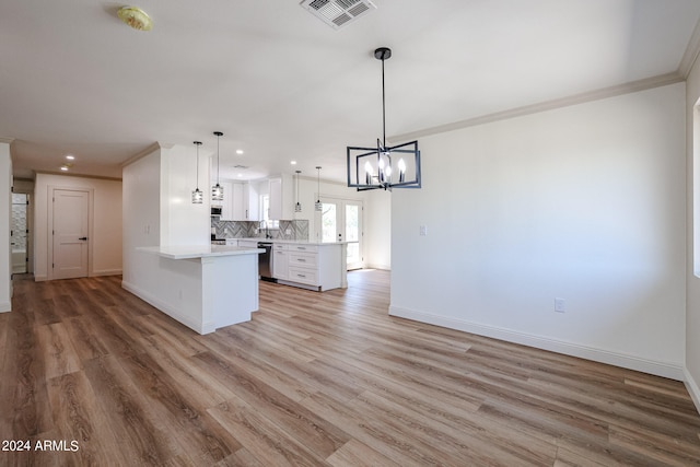 kitchen with pendant lighting, stainless steel dishwasher, kitchen peninsula, light wood-type flooring, and white cabinets