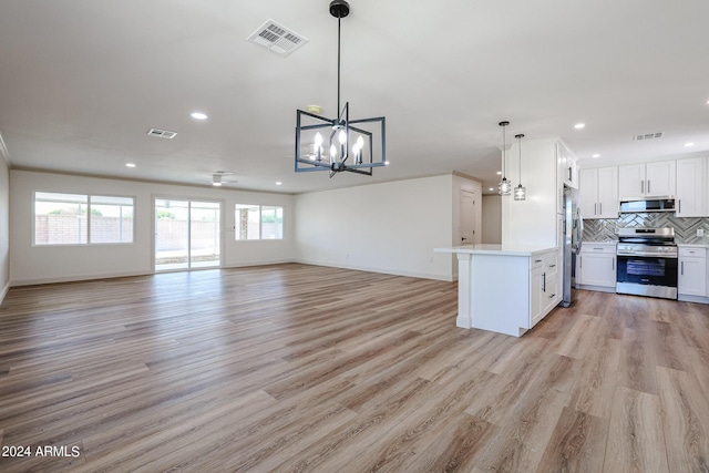 kitchen featuring visible vents, appliances with stainless steel finishes, open floor plan, and decorative backsplash