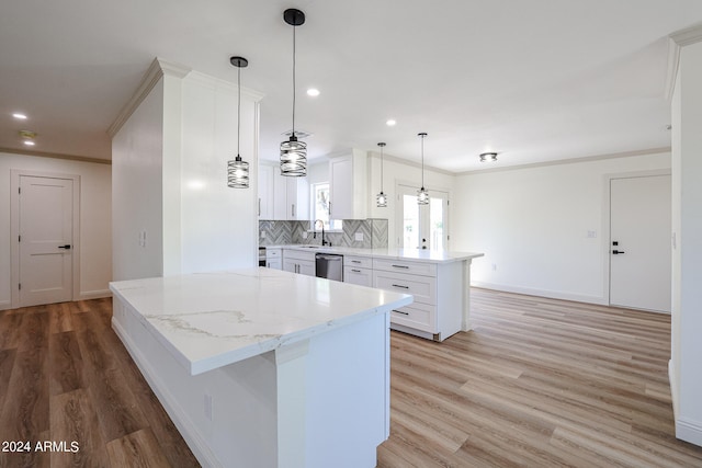 kitchen featuring dishwasher, kitchen peninsula, white cabinets, and light hardwood / wood-style floors