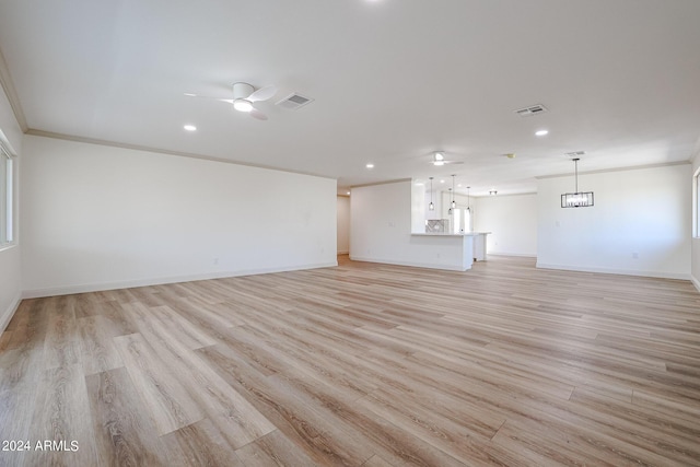 unfurnished living room featuring light wood-type flooring, baseboards, crown molding, and ceiling fan with notable chandelier