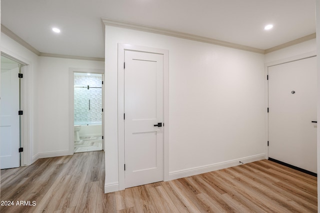 interior space with crown molding and light hardwood / wood-style flooring