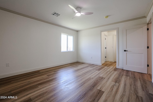 spare room featuring ornamental molding, ceiling fan, and light hardwood / wood-style floors