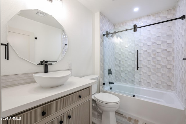 full bathroom featuring combined bath / shower with glass door, vanity, and toilet