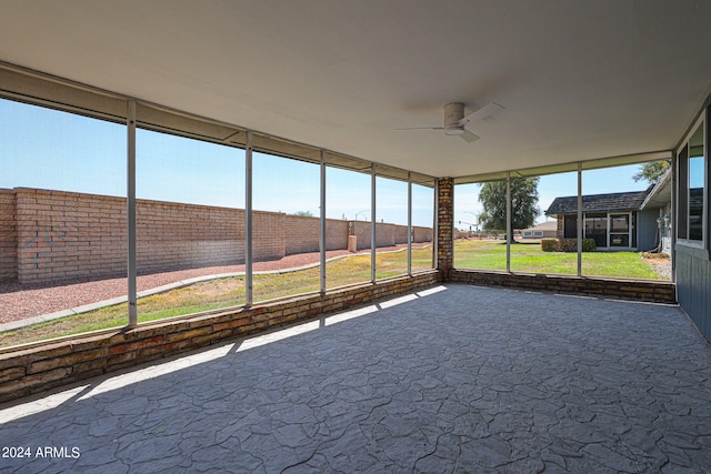 unfurnished sunroom with ceiling fan