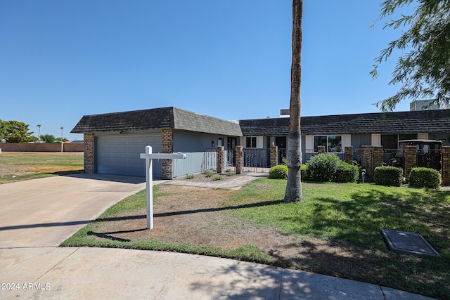 view of front of house featuring driveway, a front yard, a garage, and fence