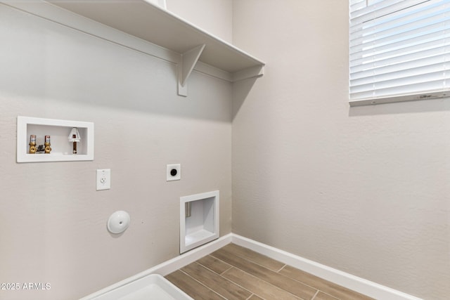 5844 E Covey Ln, Phoenix, AZ 85054 - laundry room with washer hookup, hookup for an electric dryer, wood tiled floors, baseboards, and hookup for a gas dryer