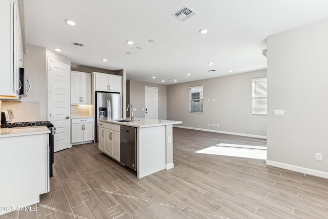5844 E Covey Ln, Phoenix, AZ 85054 - kitchen featuring appliances with stainless steel finishes, a sink, baseboards, light wood-style floors, and recessed lighting