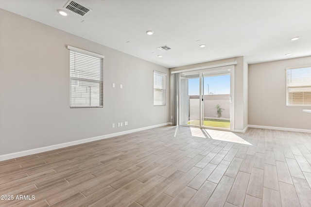 5844 E Covey Ln, Phoenix, AZ 85054 - unfurnished room featuring light wood-style flooring, plenty of natural light, baseboards, and recessed lighting