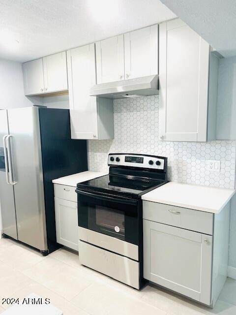 kitchen with range with electric cooktop, gray cabinetry, backsplash, light tile patterned floors, and stainless steel fridge with ice dispenser