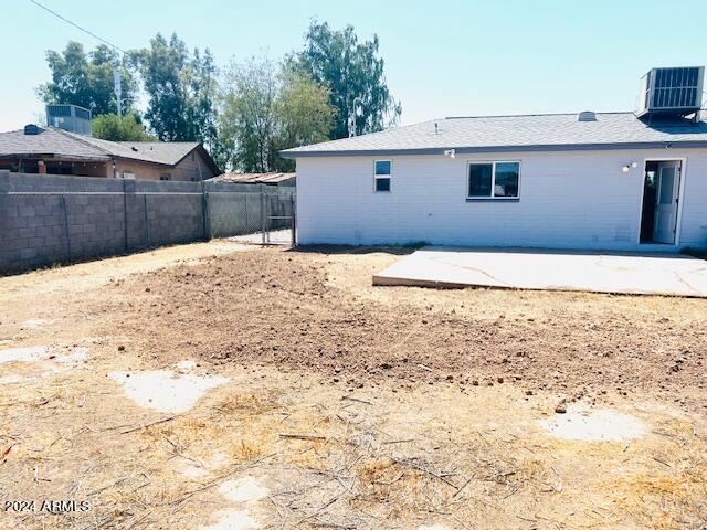 back of property featuring a patio area and central AC