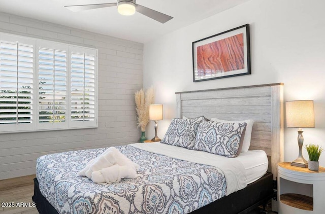 bedroom with ceiling fan and hardwood / wood-style floors