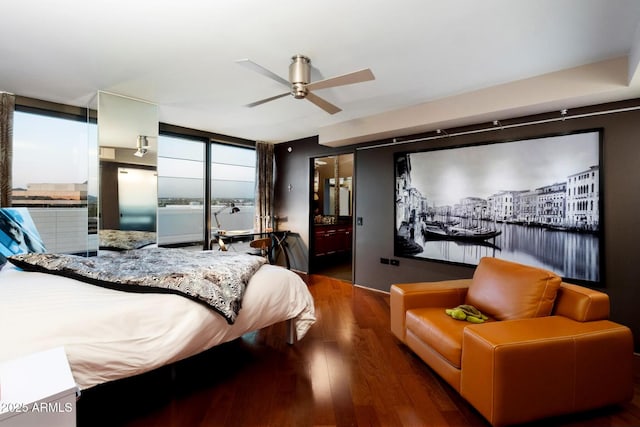 bedroom featuring expansive windows, wood finished floors, and a ceiling fan