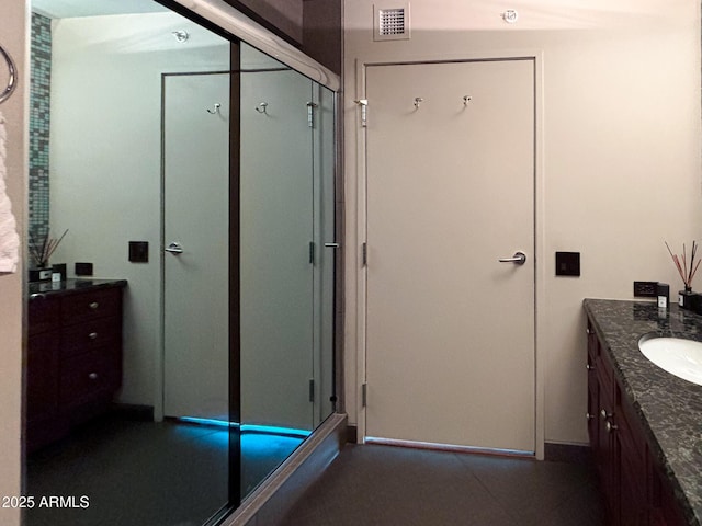 full bath with visible vents, a stall shower, and vanity