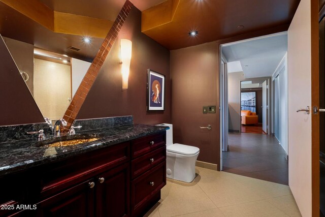 bathroom with visible vents, toilet, and vanity