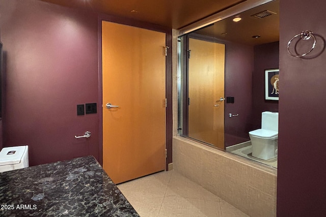 full bath featuring tile patterned floors, visible vents, toilet, and a shower with shower door
