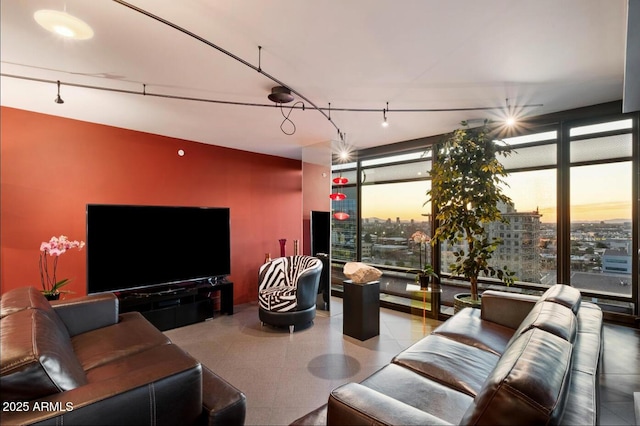 living area with a city view, floor to ceiling windows, and a healthy amount of sunlight