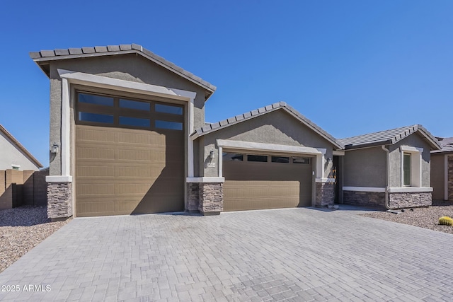 9934 E Orange Grove St, Florence, AZ 85132 - single story home featuring stone siding, a garage, stucco siding, a tile roof, and driveway
