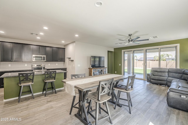 9934 E Orange Grove St, Florence, AZ 85132 - dining area featuring light wood-style floors, ceiling fan, and recessed lighting