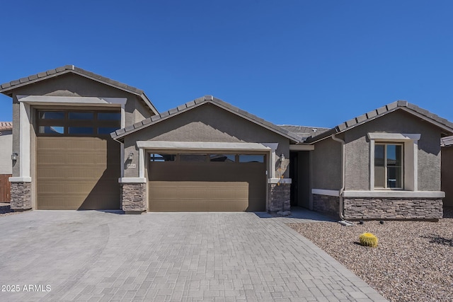 9934 E Orange Grove St, Florence, AZ 85132 - ranch-style home with stone siding, an attached garage, stucco siding, and decorative driveway